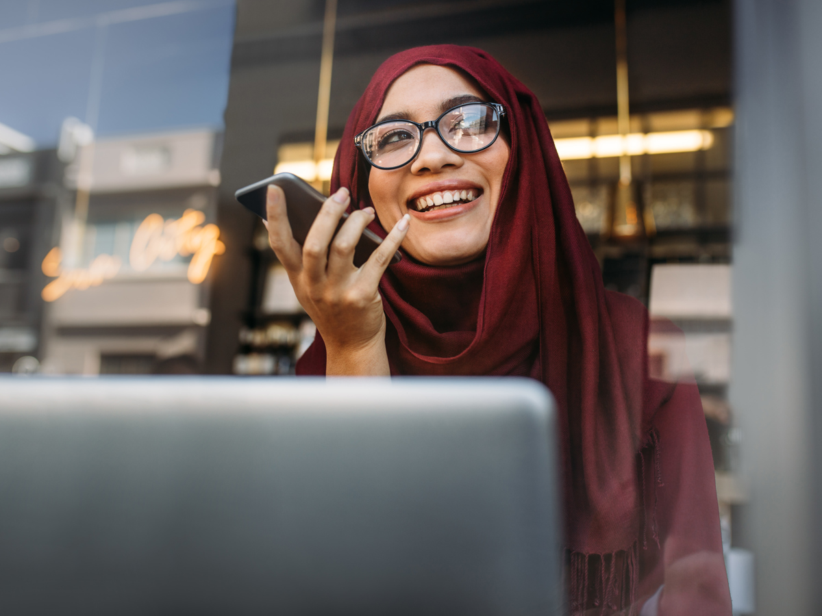 Woman In Hijab With Mobile And Laptop